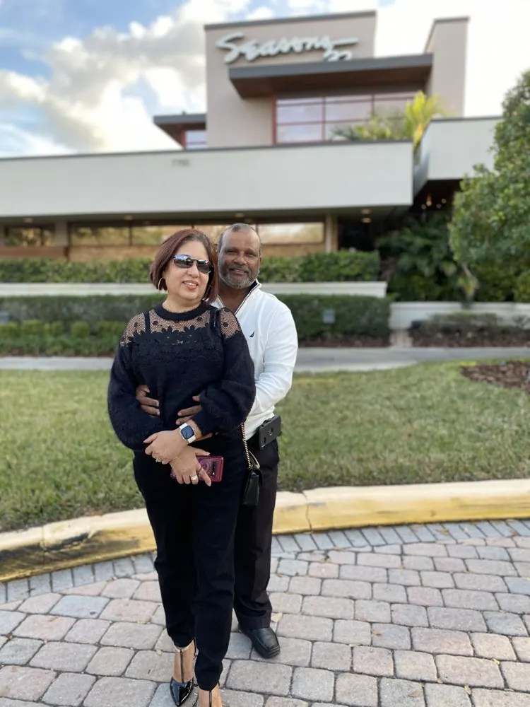 Kris Persaud and his wife outside a restaurant