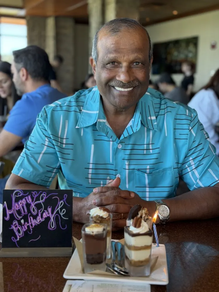 Kris Persaud in a suit at a formal event
