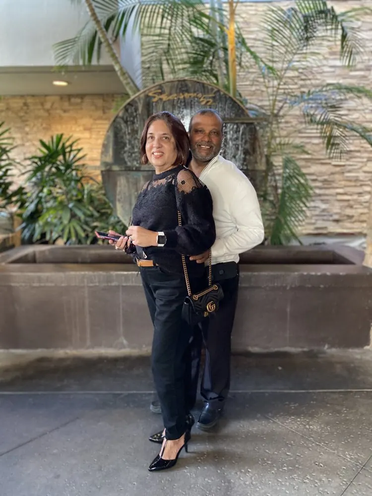 Kris Persaud and his wife on a courtyard walk